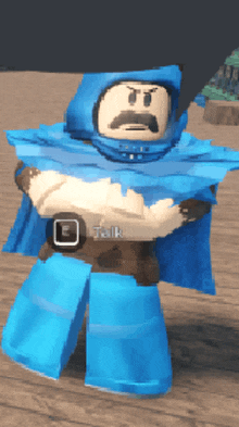 a cartoon character wearing a blue cape and a belt has the word talk on his chest