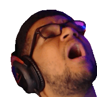 a man wearing headphones and glasses is yawning .