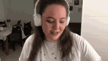 a woman wearing white headphones and a white shirt