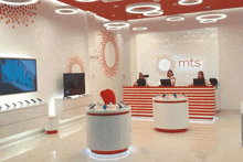 the inside of a mts store with a red and white striped counter