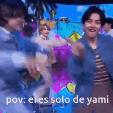 a group of men are dancing in front of a colorful background and the caption says pov : eres solo de yami .