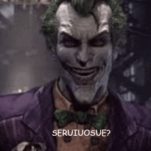 the joker is wearing a purple suit and bow tie and smiling with the words seruiousue written below him .