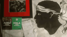 a poster that says hola on it next to a picture of a man