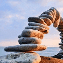 a pile of rocks stacked on top of each other on a rocky beach .