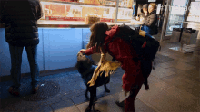 a woman petting a dog in front of a counter that has a sign that says ' gourmet beef '