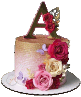 a pink and gold cake with flowers and a letter a on top