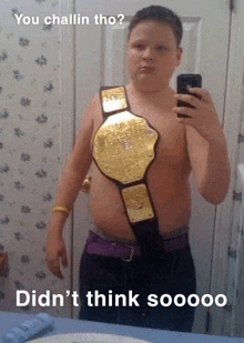 a young boy is taking a selfie with a wrestling belt around his chest