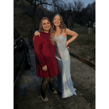 a woman in a red top and a woman in a blue dress are posing for a photo