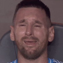 a close up of a man 's face with tears running down his face .