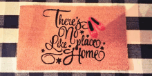 a pink door mat that says there 's no place like home