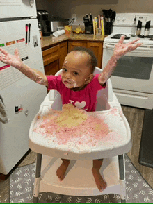 a baby is sitting in a high chair with a messy face