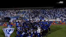 a group of soccer players are posing for a picture with a banner that says ' bayath hilal ' on it