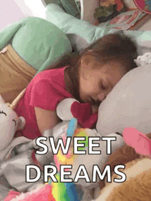 a little girl is sleeping in a bed with a stuffed animal and the words sweet dreams written on the bottom .