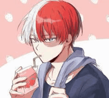 a young man with red and white hair is drinking a strawberry juice through a straw .