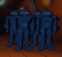 a group of blue robots are standing in a room