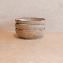 three bowls stacked on top of each other on a table