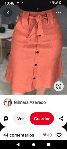 a screenshot of a woman wearing a peach skirt