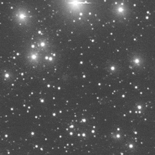 a black and white image of a starry sky with a few stars visible