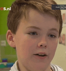 a close up of a boy 's face with os.nl written on the bottom