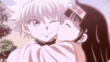 a girl is kissing a boy on the cheek in an anime