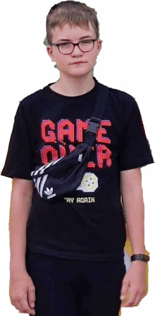 a boy wears a black shirt that says game over