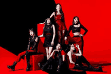 a group of girls are standing next to each other on a red and black background .