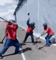 a group of men are holding hammers in front of a wall and the word ban is on the bottom