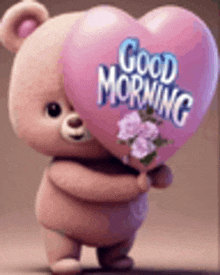 a teddy bear is holding a heart with the words `` good morning '' on it .