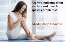 a woman sits on a yoga mat holding her knee in pain with a meds shop pharma ad behind her