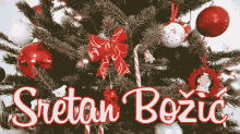 a christmas tree with red and white decorations and the words sretan bozic