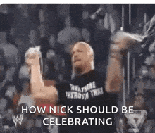 a man is standing in front of a crowd with his fist in the air and says `` how nick should be celebrating '' .