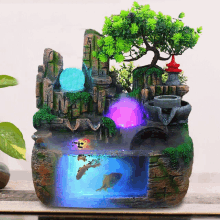 a water fountain with a fish tank and a tree in it