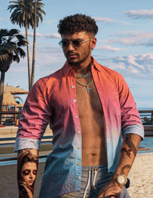 a shirtless man with a tattoo of a woman on his arm is standing on a beach