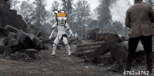 a storm trooper is standing in front of a pile of bricks .