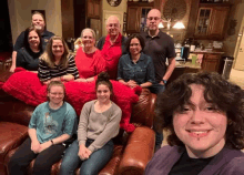 a group of people posing for a picture including a girl with a tattoo on her forehead