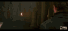 a group of people are standing next to each other in a dark room in a movie .