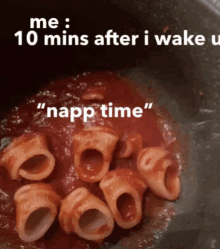 a pot of pasta with tomato sauce and the words " nap time "