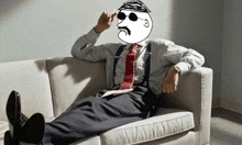 a man in a suit and tie is laying on a couch .