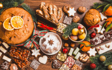 a wooden table topped with a variety of christmas foods