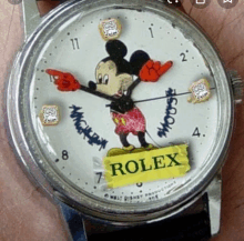 a rolex watch with a mickey mouse sticker on it