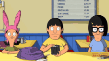 three bob 's burgers characters sit at a table with a menu in the background