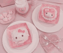 two plates of food with a hello kitty and my melody cake on them on a pink table .