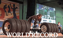 a man is lifting a barbell on top of a pile of tires with the words world record on the bottom