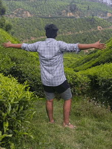 a man with his arms outstretched in a field