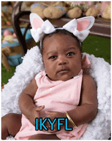 a baby wearing bunny ears has the name ikyfl on the bottom