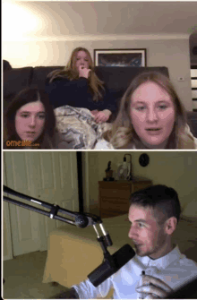 a man is talking into a microphone while two girls sit on a couch