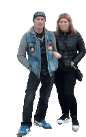 a man in a denim jacket and a woman in a black jacket are standing next to each other on a white background .