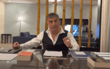 a man sitting at a desk with a book titled ' a foreign language ' on the table