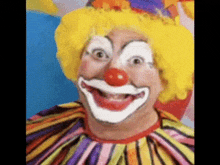 a clown with a yellow wig and a red nose