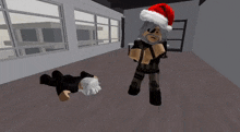 a person wearing a santa hat is standing next to a person laying on the floor in a room .